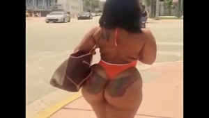 sexy latina in swimsuit walking on the street