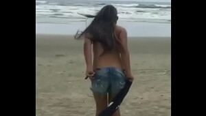 hot taking off her shorts on the beach