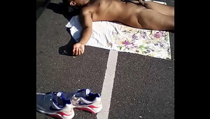 Suntanning naked in public park